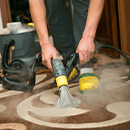 Janitor steam cleaning floors