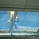 Worker window washing with squeege